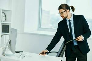 The man in a suit near the desktop work process Lifestyle photo