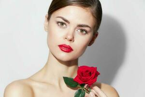 Woman with rose Red lips charm bare shoulders makeup photo