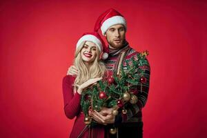 man and woman christmas tree toys fun holiday red background photo
