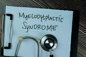 Concept of Meylodysplastic Syndrome write on paperwork with stethoscope isolated on Wooden Table. photo