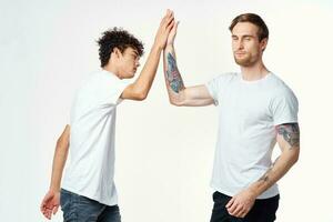 two friends in t-shirts holding hands emotions positive joy photo