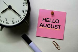 Hello August text on sticky notes isolated on office desk photo