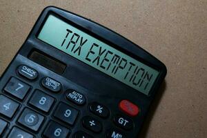 Tax Exemption write on calculator isolated on white board background. photo