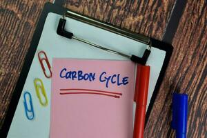 Carbon Cycle write on sticky notes isolated on Wooden Table. photo