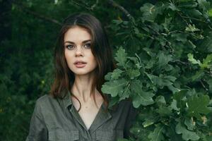 woman in the forest Attractive look green suit bush trees photo