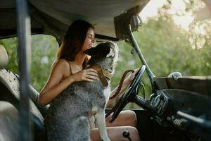 Woman and her husky dog happily traveling in car smile with teeth autumn walk with pet, travel with dog friend photo