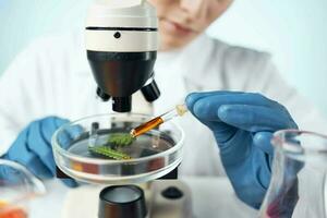 woman in laboratory adjusts microscope research analyzes technology photo