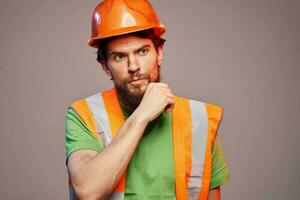 Man in orange paint construction security professional gray background photo