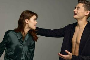 Happy man and aggressive woman emotions gray background cropped view of suit photo