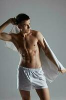 sporty man with muscular torso white towel photo