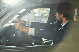 bearded man in a suit in a car a trip to work self confidence photo