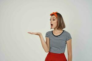 pretty woman with a bandage on her head in a striped t-shirt light background photo