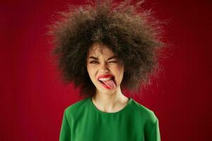 Portrait of a charming lady Afro hairstyle green dress emotions close-up color background unaltered photo