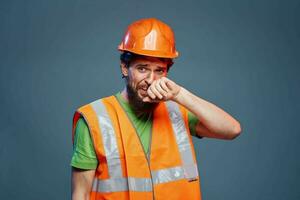 Bearded man in orange paint construction safety hard work photo