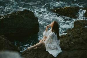 woman with wet hair in white dress stones nature travel unaltered photo