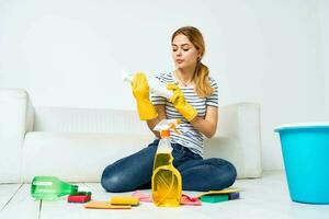 cleaning lady with detergent in hands in the room housekeeping photo