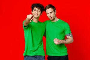 two friends hugging in green T-shirts Friendship team communication photo