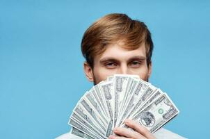 man with wad of money finance official blue background photo