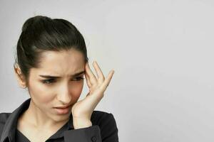 woman in black shirt holding his head depressed isolated background photo