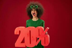 Beautiful fashionable girl green dress afro hairstyle dark glasses twenty percent in hands studio model unaltered photo