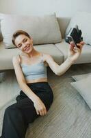 Happy smile woman holding an old camera and taking pictures of herself as a weekend photographer in home clothes with a short haircut hair without filters on a white background, free copy space photo