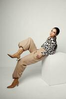 woman in fashion clothes leopard shirt brown boots photo