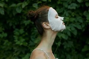 Nice woman cosmetic mask bare shoulders cropped view Closed eyes photo