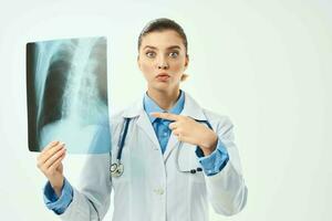 surprised radiologist showing x-ray emotion light background photo