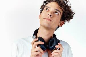 Cheerful guy with curly hair headphones technology music emotions photo