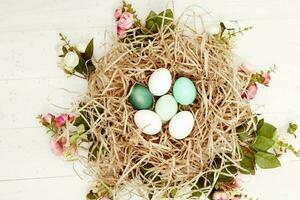 easter eggs in a basket in the form of a nest top view decoration holiday photo