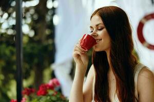 beautiful woman drinking coffee outdoors Relaxation concept photo