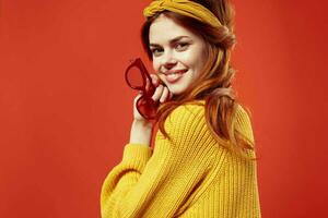 attractive woman with yellow bandage glasses in the hands of Studio accessories photo