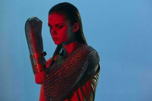 attractive woman Glamor posing red light metal armor on hand isolated background photo