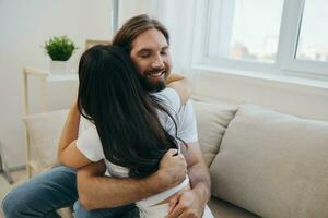 The man hugs the girl and smiles. The joy of using the family and the good psychological state after the quarrel photo