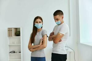 man and woman at the reception at the hospital with bactericidal layers on the shoulders covid passport photo