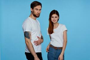 young couple in white t-shirts images of communication with him studio photo