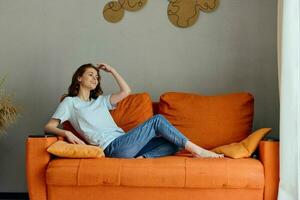 smiling woman on the couch rest fun Comfort apartments photo