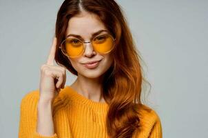 beautiful woman in yellow glasses posing fun lifestyle light background photo