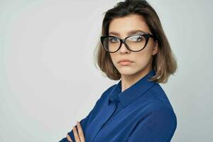 woman in blue shirt wearing glasses elegant style self-confidence studio photo