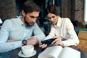 man and woman sitting in cafe breakfast business colleagues photo