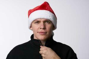 man in santa hat close-up light background holiday photo