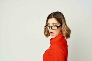 Business woman in red shirt and glasses manager work light background photo