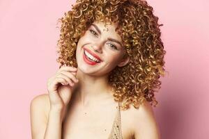 Charming model Curly hair red lips pink background smile photo