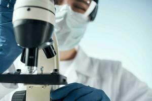 woman looking through a microscope laboratory research science experiment photo