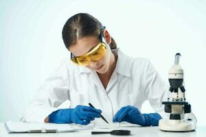 woman with microscope in laboratory research scientists photo