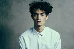 guy with curly hair in a white shirt curly hair emotions official photo