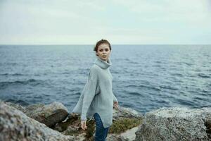 portrait of a woman sweaters cloudy sea admiring nature Lifestyle photo