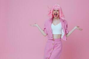 Positive young woman in a pink suit gesturing with his hands emotions fun Studio Model unaltered photo