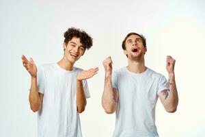 two men in white t-shirts are standing next to friendship emotions photo