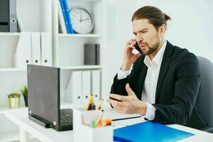 manager at the desk documents communication by phone boss photo